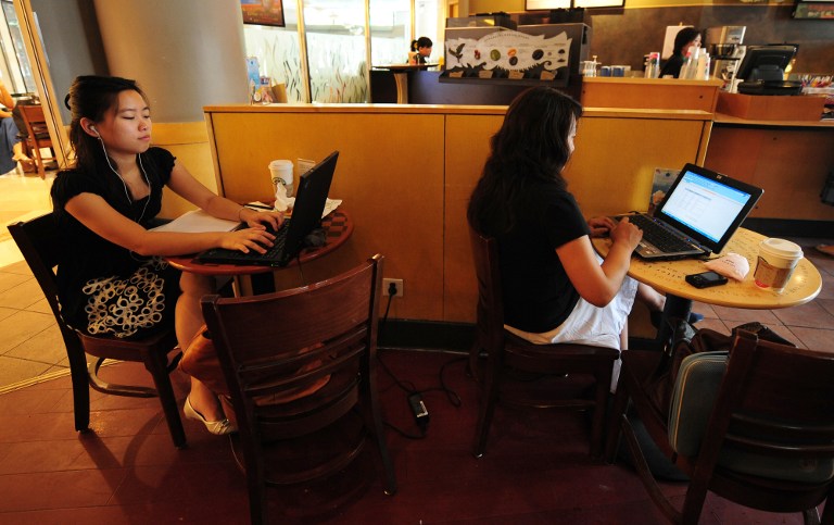 Women use their laptop computers at a wireless cafe in Beijing on July 3, 2009. Chinese billionaires Jack Ma and Zhang Jindong may get licenses this month to start phone companies in China. u00e2u20acu201d AFP pic