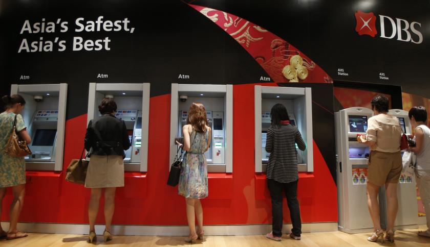 People use Development Bank of Singapore (DBS) automated teller machines (ATMs) at a branch office in Singapore February 15, 2014. u00e2u20acu201d Reuters pic