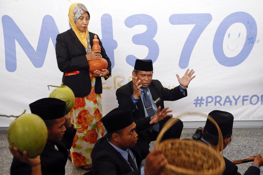 Ibrahim Mat Zin (back right), a local well-known 'bomoh' (the Malay term for a shaman), performs a ritual to help find the missing Malaysia Airlines MH370 at Kuala Lumpur International Airport March 12, 2014. u00e2u20acu201d Reuters pic