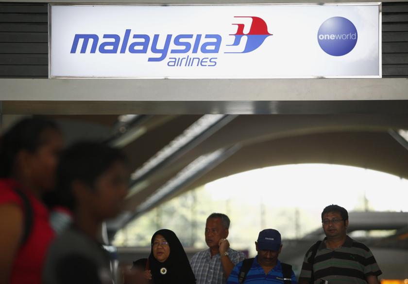 People walk under a Malaysia Airlines sign at Kuala Lumpur International Airport in Sepang March 8, 2014. u00e2u20acu201d Reuters pic