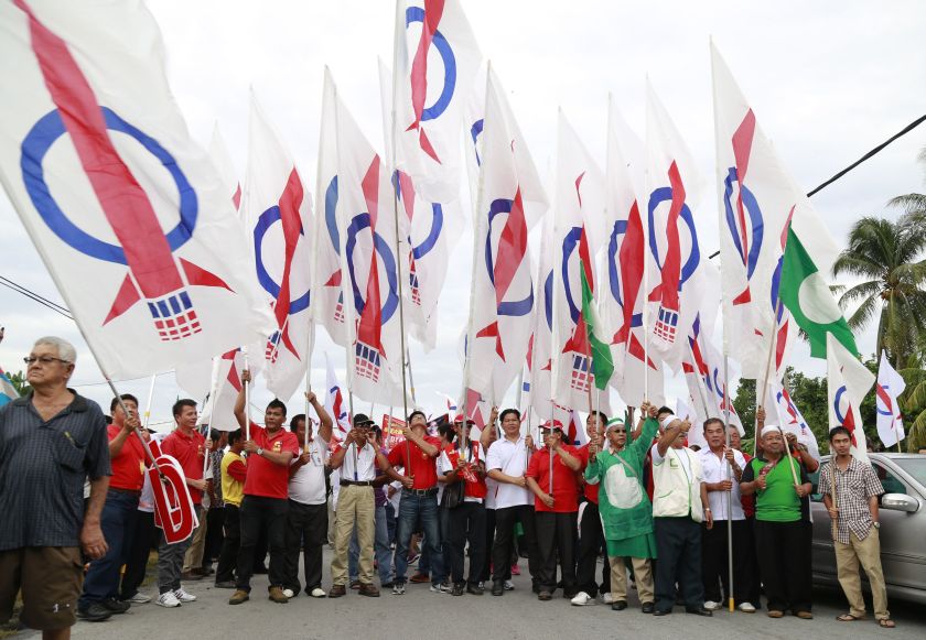DAP and PAS supporters are seen armed with party flags on nomination day for the Teluk Intan by-election, May 19, 2014. u00e2u20acu201d Picture by Marcus Pheong