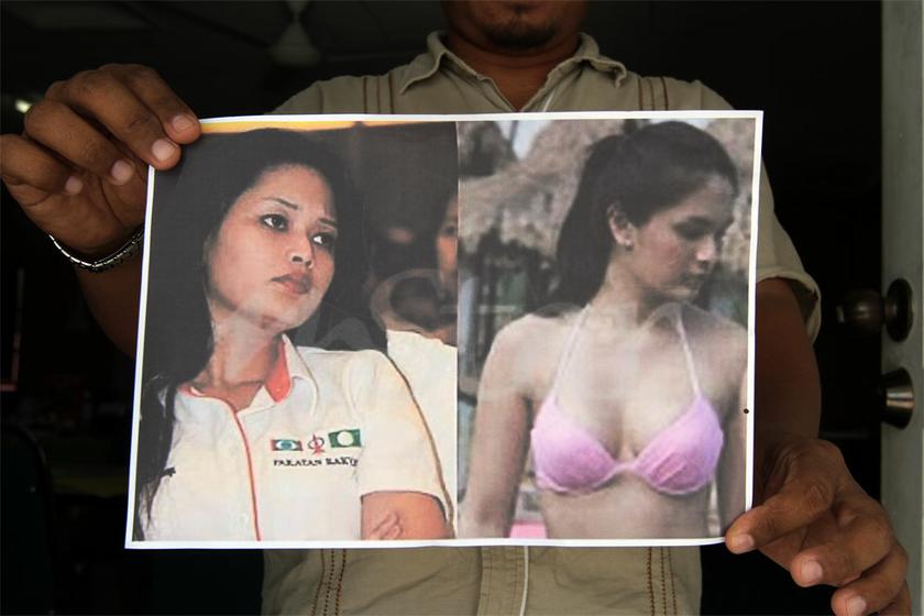 Teluk Intan PAS campaign deputy director Salman Saleh holds up a poster showing DAP candidate for the Teluk Intan by-election, Dyana Sofya Mohd Daud, (left) next to a bikini-clad woman whom she is said to resemble, on May 24, 2014. u00e2u20acu201d Picture by Yusof Ma