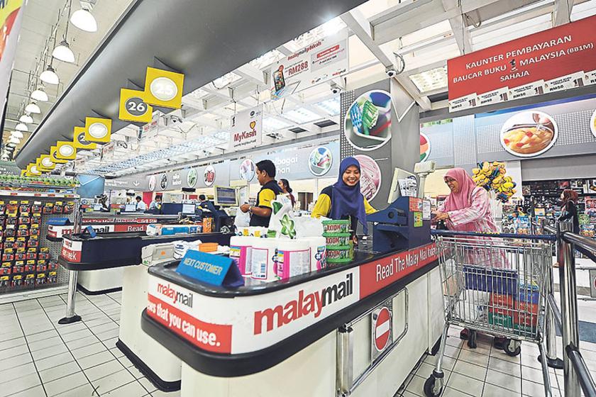 Mydin has utilised cashier counters as additional advertising platforms. u00e2u20acu201d Picture by Azinuddin Ghazali