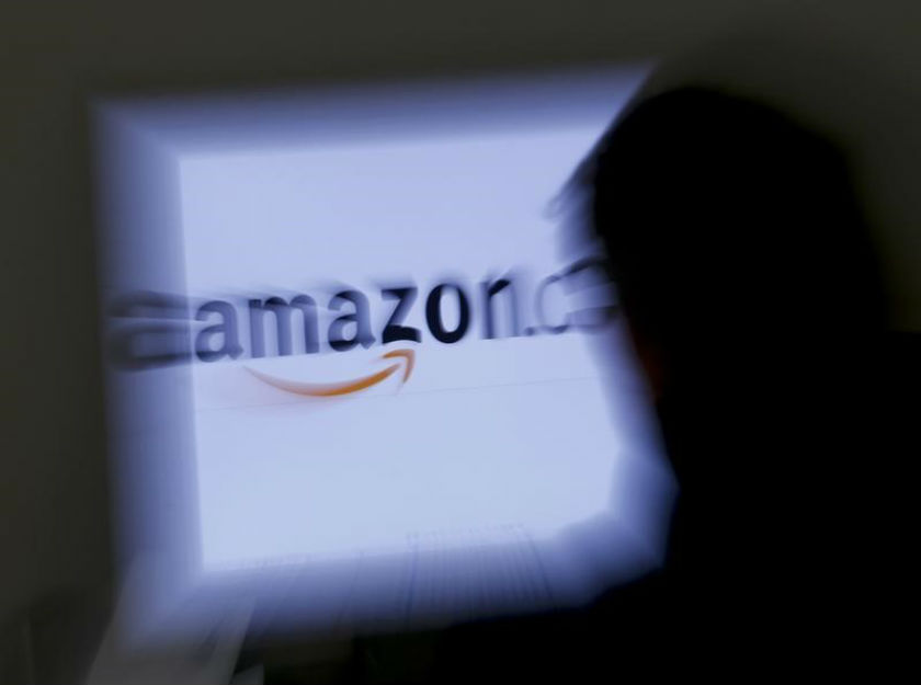 A zoomed illustration image of a man looking at a computer monitor showing the logo of Amazon is seen in Vienna November 26, 2012. u00e2u20acu201d Reuters pic