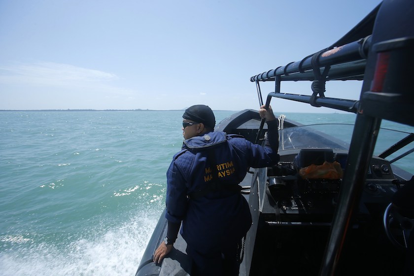 A Malaysia Maritime officer looks out into the sea during a search and rescue in Kuala Langat June 18, 2014. u00e2u20acu201d Reuters pic
