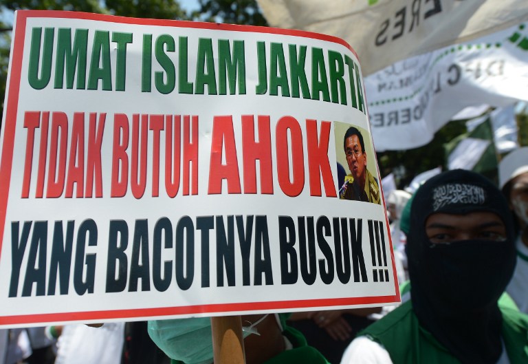 Indonesian members of the Islamic Defender Front (FPI) shout slogans during a protest against Jakarta's vice governor Basuki Tjahaja Purnama (alias Ahok) outside the Jakarta parliament building in Jakarta on September 24, 2014. u00e2u20acu201d AFP