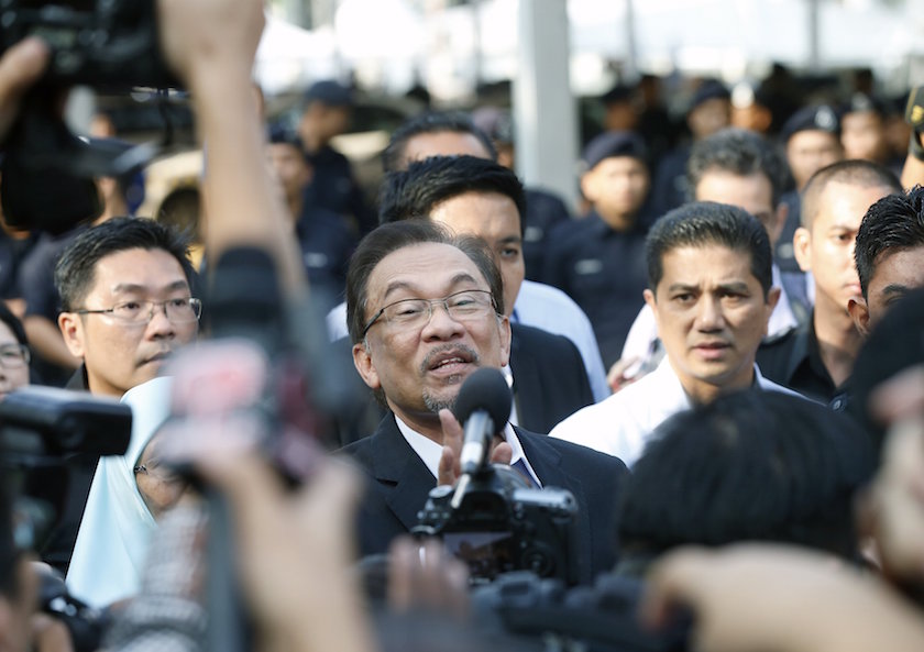 Datuk Seri Anwar Ibrahim is surrounded by supporters and members of the media as he arrives at the Palace of Justice for his final appeal against a conviction for sodomy in Putrajaya October 28, 2014. u00e2u20acu201d Reuters pic