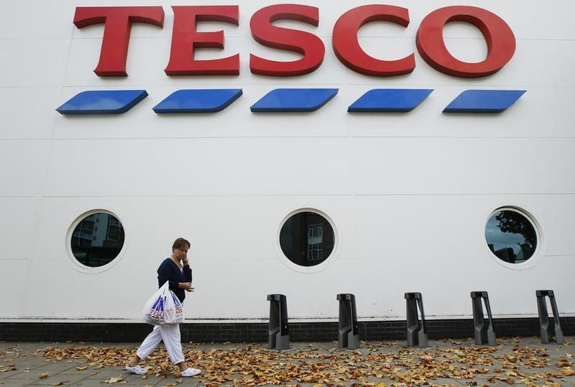 A shopper passes a Tesco supermarket in London October 5, 2011. u00e2u20acu201d Reuters pic