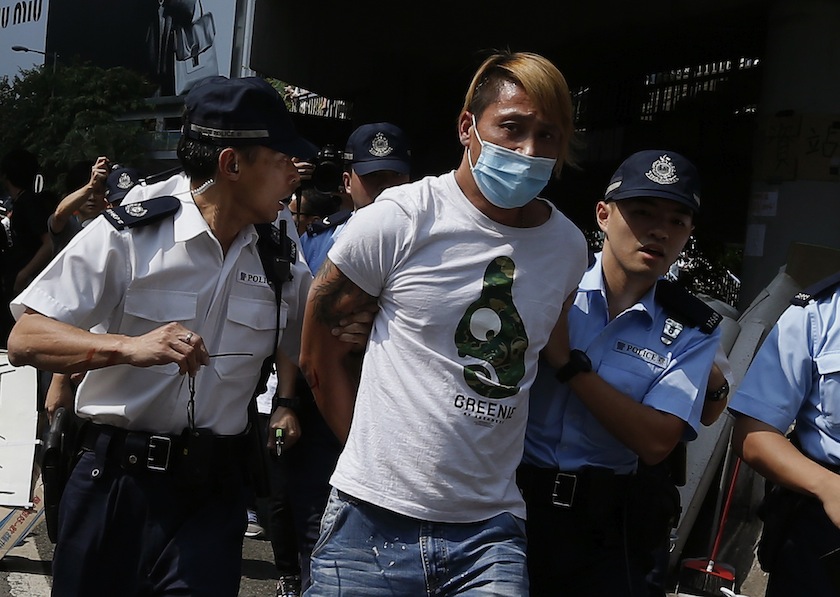An anti-Occupy Central protester is taken away by the police during a confrontation in Hong Kong October 13, 2014. — Reuters pic