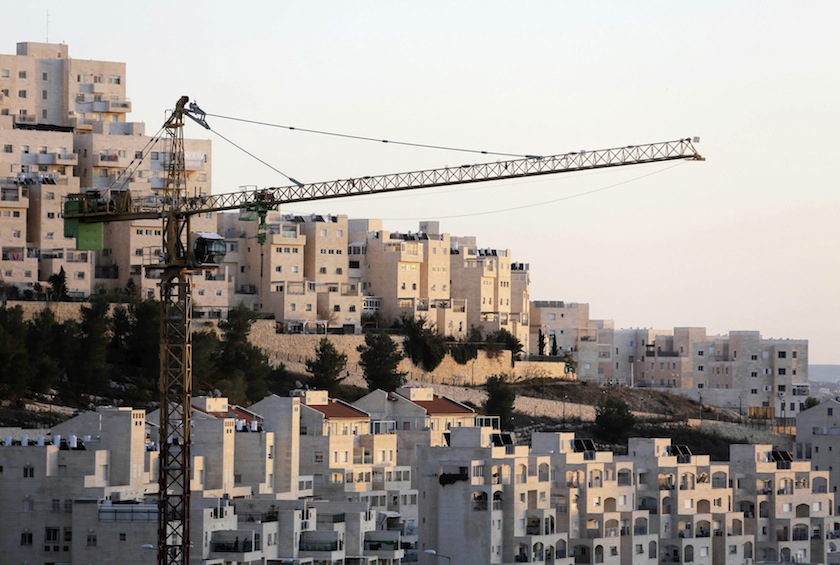 A crane is seen next to homes in a Jewish settlement known to Israelis as Har Homa and to Palestinians as Jabal Abu Ghneim, in an area of the West Bank that Israel captured in a 1967 war and annexed to the city of Jerusalem, in this January 3, 2014 file p