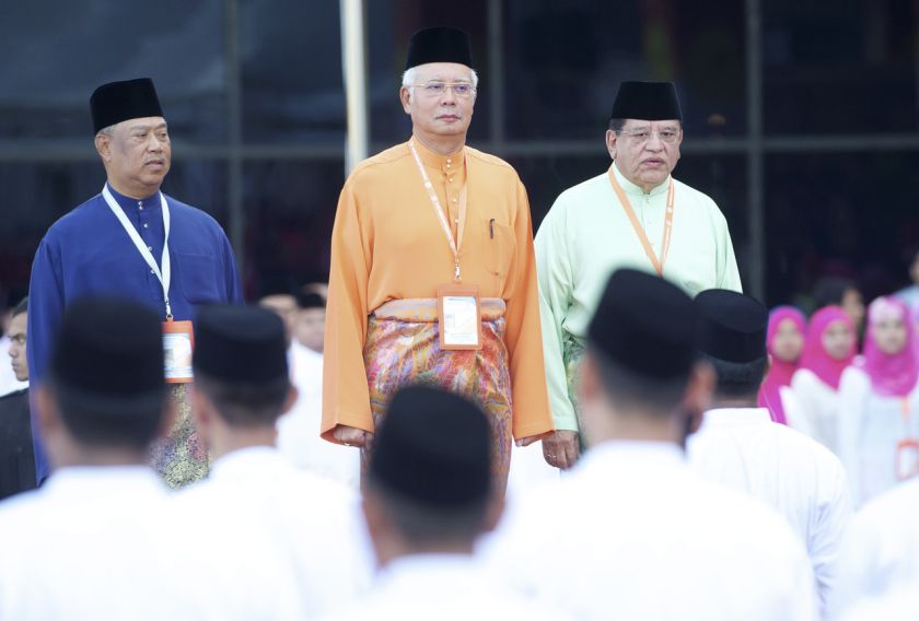 Datuk Seri Najib Tun Razak (centre) prepares to inspect the parade, mounted by 150 members of the three Umno wings, Wanita, Youth and Puteri, at PWTC before officially opening the 2014 Umno General Assembly, November 27, 2014. u00e2u20acu201d Bernama pic