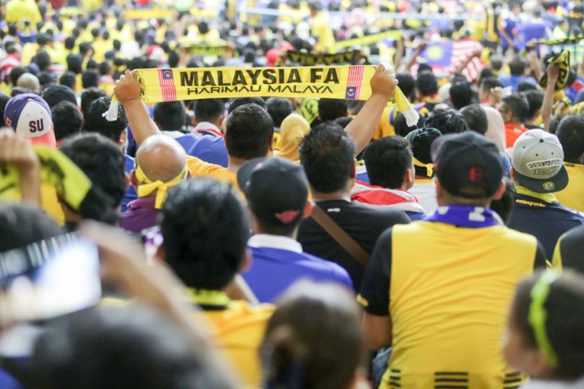 A Malaysian football fan holds up a banner during the AFF Suzuki Cup 2014 semi-final match at the Shah Alam Stadium, December 7, 2014. u00e2u20acu201d Picture by Choo Choy May