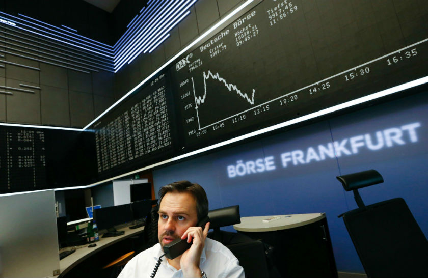 A trader is pictured at his desk in front of the German share price index DAX board at the Frankfurt stock exchange December 2, 2014. u00e2u20acu201d Reuters pic