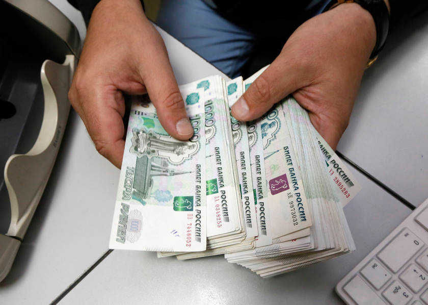 An employee counts Russian ruble banknotes at a private company's office in Krasnoyarsk, Siberia, December 17, 2014. u00e2u20acu201d Reuters pic
