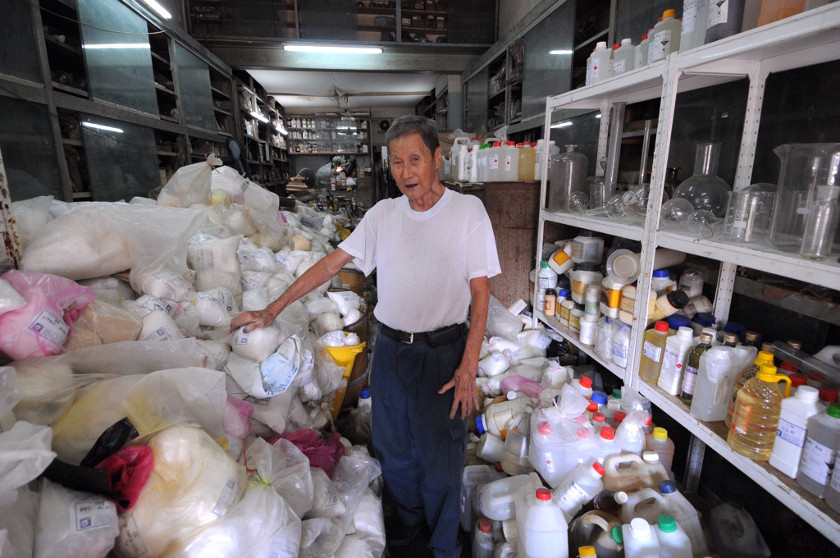Chemical shop Liangtraco's 91-year-old owner Ong Liang Ching in his cluttered shop which he says will take months to slowly clear up as it involved dangerous chemicals.
