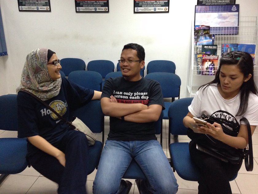 Nik Nazmi Nik Ahmad (centre) is detained at the Jinjang police station for joining a pro-Anwar rally yesterday. He is with his wife Imaan Abdul Rahim (left) and lawyer Melissa Sasidaran. u00e2u20acu201d Picture provided by PKR