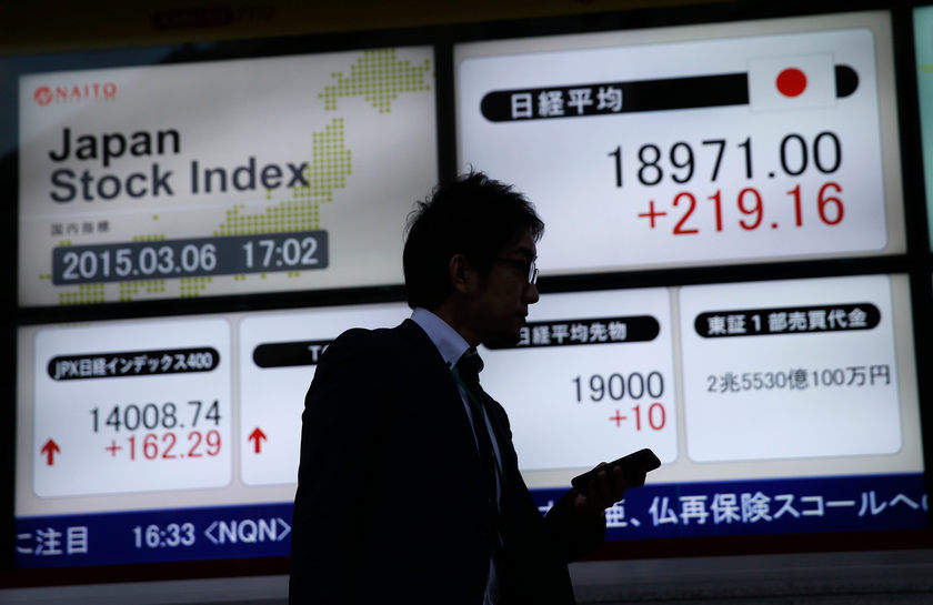 A man walks past an electronic board showing Japan's Nikkei average outside a brokerage in Tokyo March 6, 2015. Japan's Topix Index fell the most today (March 9) since February 3.  u00e2u20acu201d Reuters pic