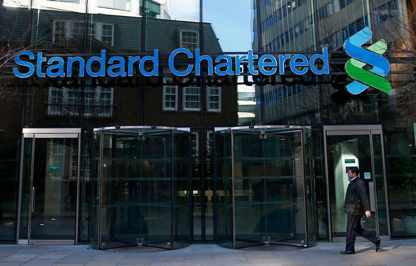 A man walks past the head office of Standard Chartered bank in the City of London February 27, 2015. u00e2u20acu201d Reuters pic