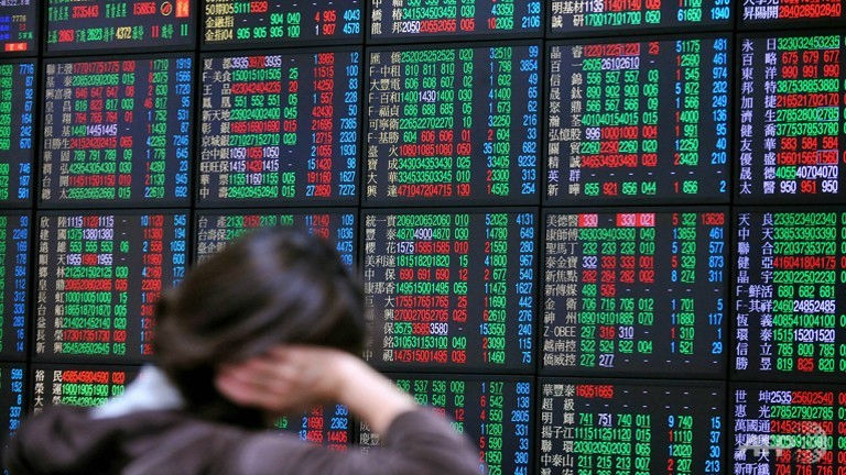 An investors looks at counters of the Taiwan Stock Exchange at a brokerage in Taipei. u00e2u20acu201d AFP pic