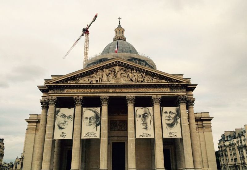 Artistic impressions of the four French Resistance fighters, including two women, interred at The Pantheon last Thursday hang majestically over its entrance. ― Picture by Helen Hickey