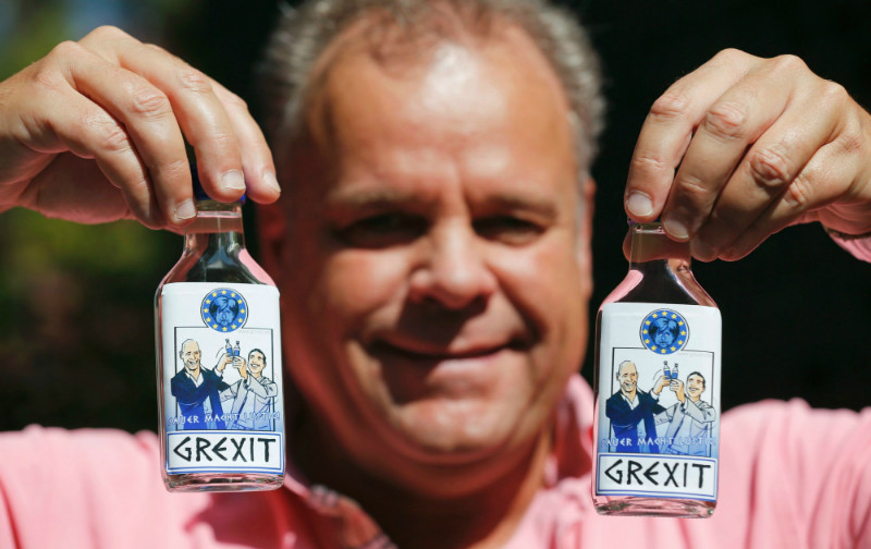 German entrepeneur Uwe Dahlhoff holds up bottles of ‘Grexit’ vodka, labelled with the caricatures of Greek Prime Minister Alexis Tsipras (right) and Finance Minister Yannis Varoufakis happily raising their glasses under a miserable-looking German Chancellor Angela Merkel in Hamm, Germany, June 30, 2015. — Reuters pic German entrepeneur Uwe Dahlhoff holds up bottles of ‘Grexit’ vodka, labelled with the caricatures of Greek Prime Minister Alexis Tsipras (right) and Finance Minister Yannis Varoufakis happily raising their glasses under a miserable-looking German Chancellor Angela Merkel in Hamm, Germany, June 30, 2015. — Reuters pic