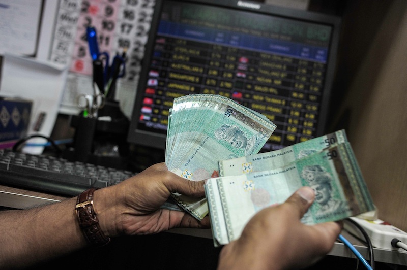 The ringgit has also weakened over the past 12 months on the risk that monetary tightening in the US will spur capital outflows. — AFP pic