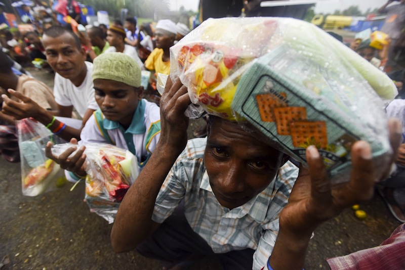 Rohingya migrants from Myanmar wait in line for food aid packages at a temporary shelter in Beyeun, near Langsa in Indonesia's Aceh Province, May 31, 2015.&nbsp;— Reuters pic