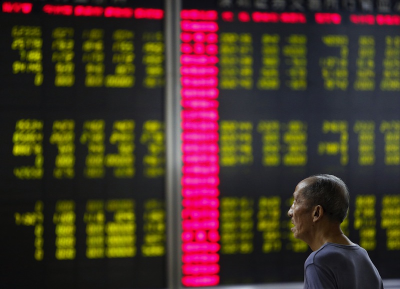An investor watches an electronic board showing stock information at a brokerage office in Beijing, China, July 7, 2015.u00c2u00a0u00e2u20acu201d Reuters pic