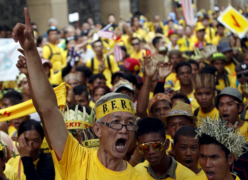 A Bersih supporter leads a group of Orang Asli, as they march to Dataran Merdeka in Kuala Lumpur August 30, 2015.  — Reuters pic