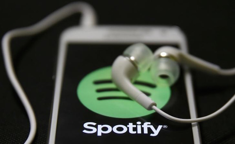 Earphones are seen on top of a smart phone with a Spotify logo on it, in Zenica February 20, 2014. u00e2u20acu201d Reuters pic