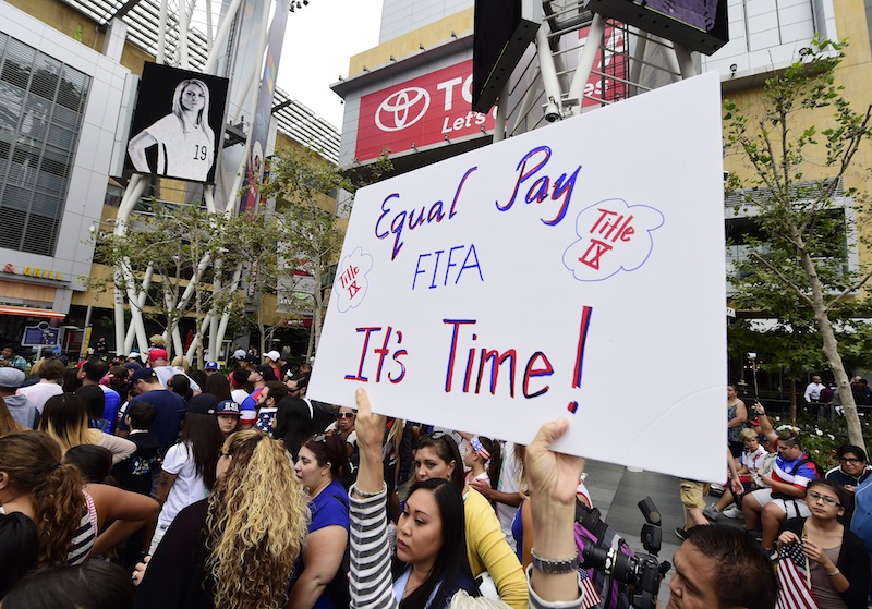 A fan holds up a sign calling for equal pay for female athletes, at the US Women's World Cup football team's championship celebration rally, at L.A. LIVE in downtown Los Angeles, California, July 7, 2015. u00e2u20acu201d AFP pic