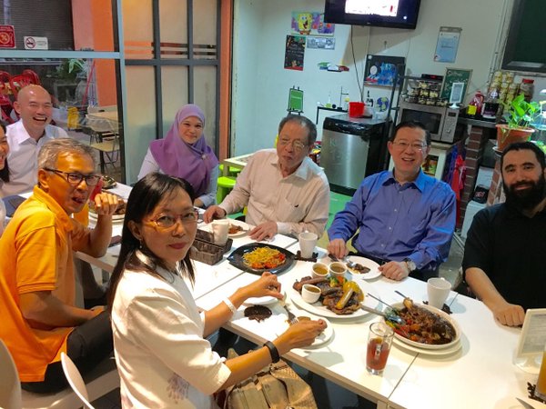 Lim Guan Eng, his father Lim Kit Siang, Seputeh MP Teresa Kok, Petaling Jaya Utara MP Tony Pua, Segambut MP Lim Lip Eng and several others, can be seen smiling as they sat together for a meal at the Damansara Perdana cafe. u00e2u20acu201d Picture courtesy of Lim Kit 