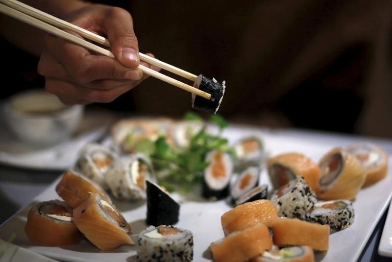 A woman uses chopsticks to eat sushi at a restaurant in La Serena, Chile in this picture released April 19, 2016. u00e2u20acu201d Reuters pic