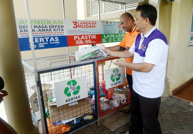 Residents place their recyclable waste into bins according to the type of material, at an apartment in Presint 8, Putrajaya May 9, 2016. u00e2u20acu201d Bernama pic