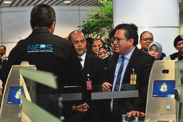 Nur Jazlan inspects the online immigration system at KL International Airport last Tuesday. He says the online system there is in dire need of an upgrade. u00e2u20acu201d Picture by Azinuddin Ghazali   