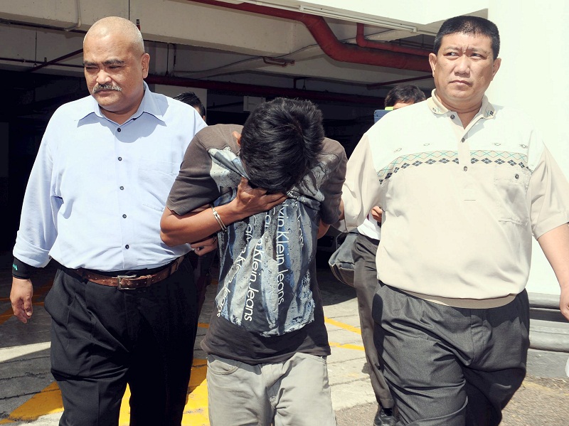 Labourer Muhammad Amirul Azwan Mohd Shakri (centre), 19, was sentenced to a total of 14 years' jail for posting insulting comments against the Tunku Mahkota of Johor, Tunku Ismail Sultan Ibrahim. u00e2u20acu201d Bernama pic