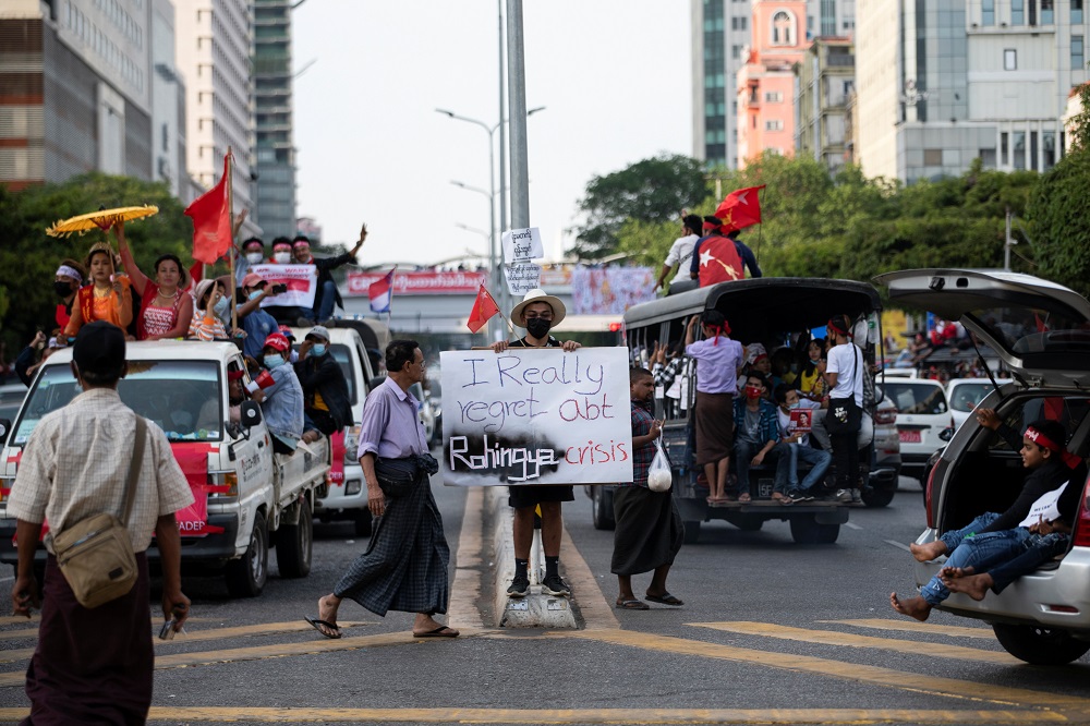 nA demonstrator stands with a placard while protesting against the military coup in Yangon February 12, 2021. u00e2u20acu201d Reuters picn