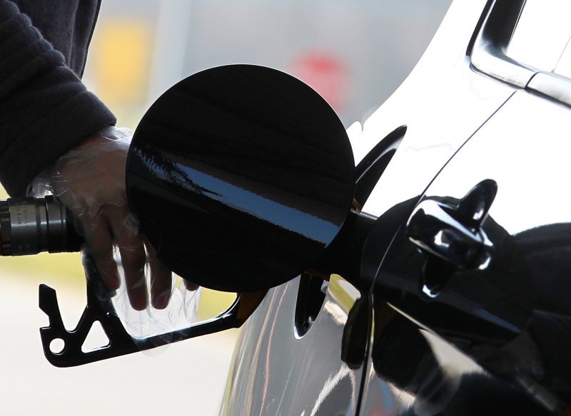 A driver pumps petrol into his car at a petrol station in Brussels March 8, 2011. REUTERS/Yves Hermann