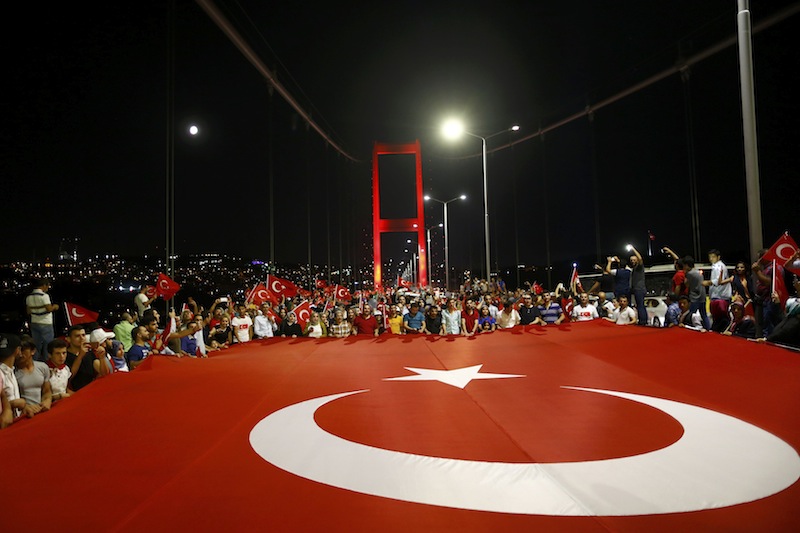 Pro-government demonstrators hold a giant Turkish flag during a march over the Bosphorus Bridge from the Asian to the European side of Istanbul, Turkey, July 21, 2016. u00e2u20acu201d Reuters pic