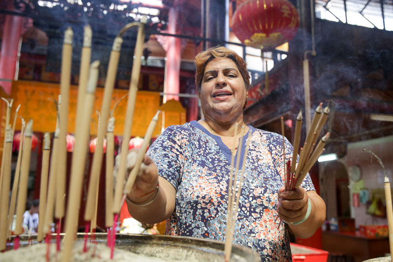 Ranjit's duties at the temple include clearing away old joss sticks placed by temple patrons