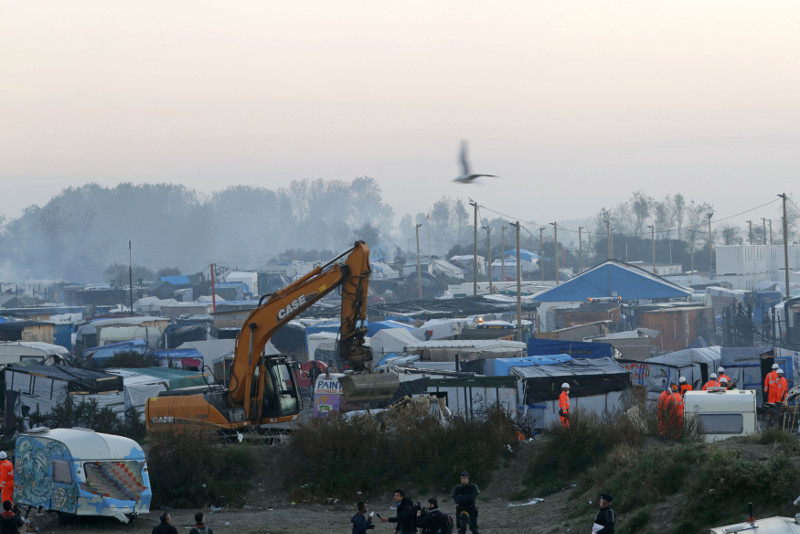 A bulldozer is used to remove debris as workmen tear down makeshift shelters during the dismantlement of the camp called the u00e2u20acu02dcJungleu00e2u20acu2122 in Calais, France, October 27, 2016. u00e2u20acu201d Reuters pic
