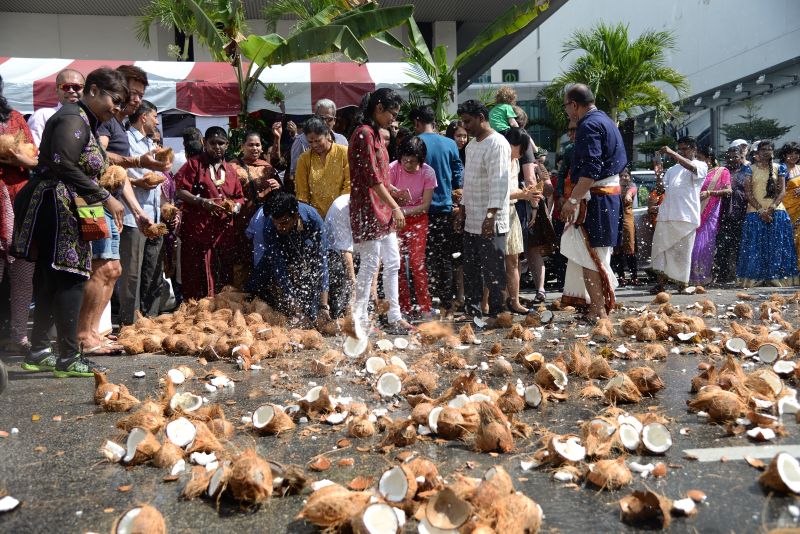 Devotees smash coconuts along the road in George Town as the Chariot passes by, February 8, 2017. u00e2u20acu2022 Picture by KE Ooi