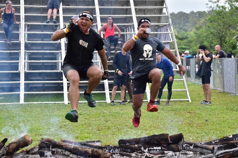 Two participants jumping for joy after completing the Spartan Race last Sunday.