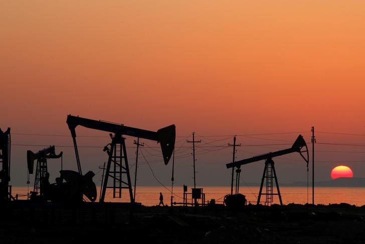 Pump jacks are silhouetted against the rising sun on an oilfield in Baku, Azerbaijan January 24, 2013. u00e2u20acu201d Reuters picn