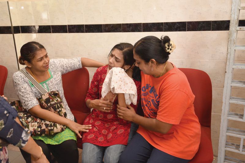 Relatives try to console T. Nhaveen's mother, Shanti (centre), at the Penang Hospital yesterday. Nhaveen was assaulted by two other teenagers after an altercation outside a burger stall in Penang. u00e2u20acu2022 Malay Mail picn