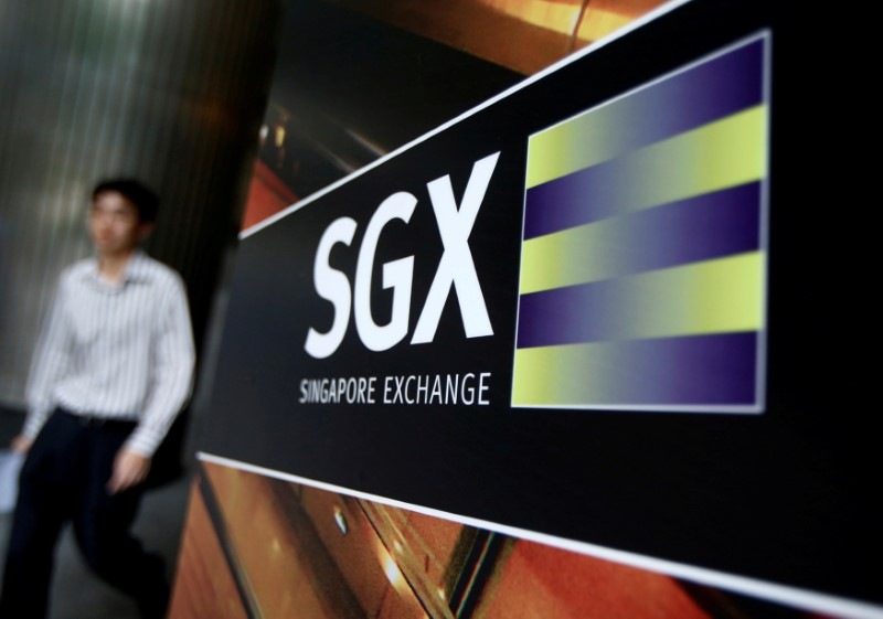 An office worker walks past the Singapore Stock Exchange April 23, 2014. u00e2u20acu201d AFP pic