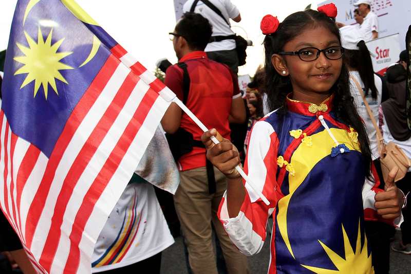 A participant wearing and carrying Malaysian flag during Anak Anak Malaysia Walk at Dataran Kemerdekaan in Shah Alam August 27, 2017 u00e2u20acu201d Picture by Miera Zulyana Abdul Rahmann