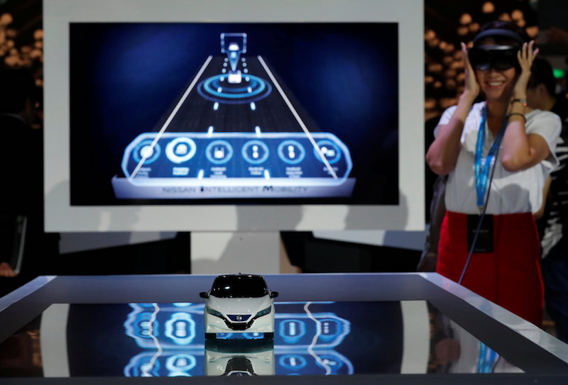 A woman wears 3D headset as she listens an explanation about Nissan Motor Cou00e2u20acu2122s new Leaf, the latest version of the worldu00e2u20acu2122s top selling electric vehicle (EV), during its world premiere in Chiba, Japan, September 6, 2017. u00e2u20acu201d Reuters pic