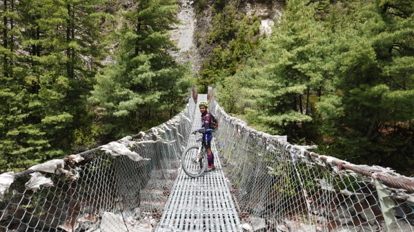 Nur Azhami crosses a suspended bridge on her way to the summit of Annapurna in Nepal. u00e2u20acu201d Picture by Malay Mail