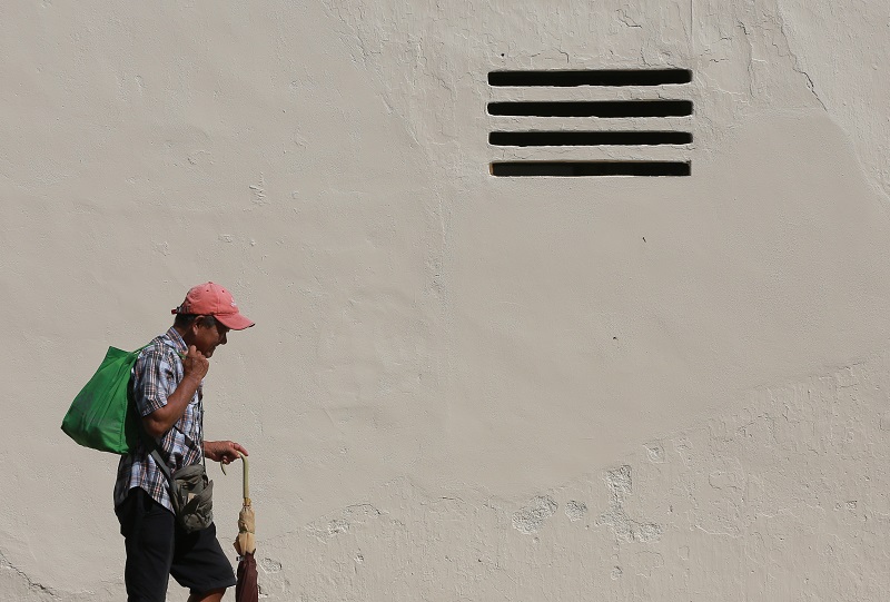 A man walks past a wall along Jalan Bijih Timah in Ipoh where Zacharevic’s famous mural — ‘Girl with Stool and Birdcage’ — used to be.